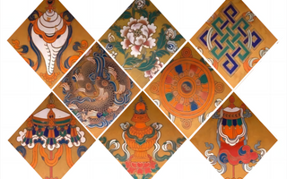 A point of focus for mediation and contemplation: the eight auspicious symbols placed on lotus pedestals in front of statues of the Buddha