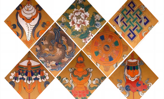 A point of focus for mediation and contemplation: the eight auspicious symbols placed on lotus pedestals in front of statues of the Buddha